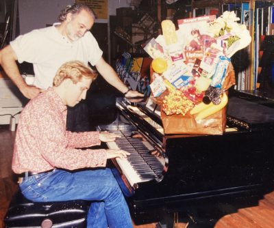 Mark Kostabi playing piano with Tom Pergola